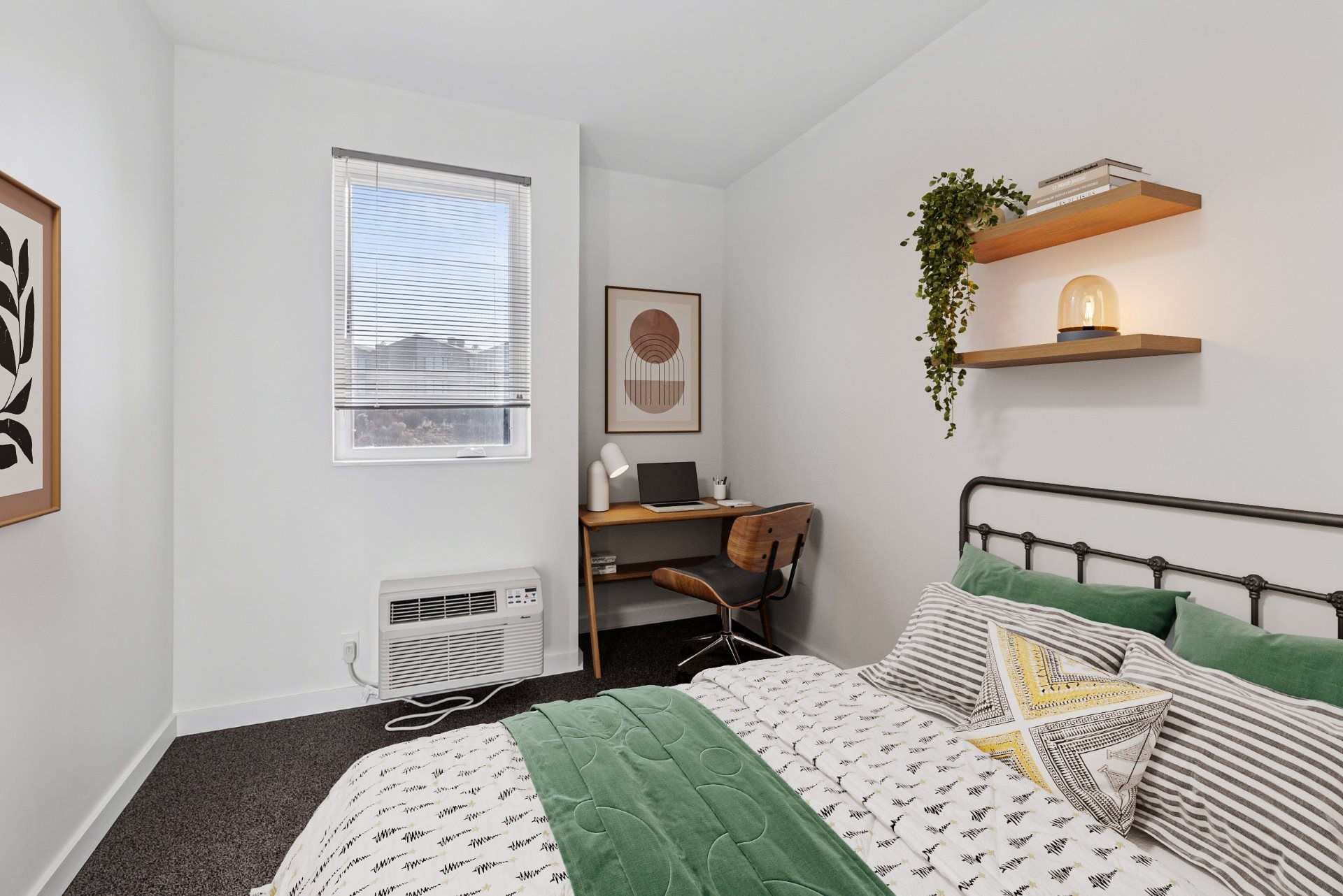 A bedroom with a bed, desk, and window.